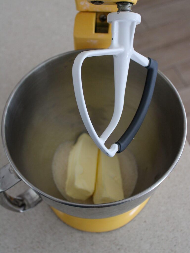 butter and sugar in a metal stainless steel kitchen aid bowl