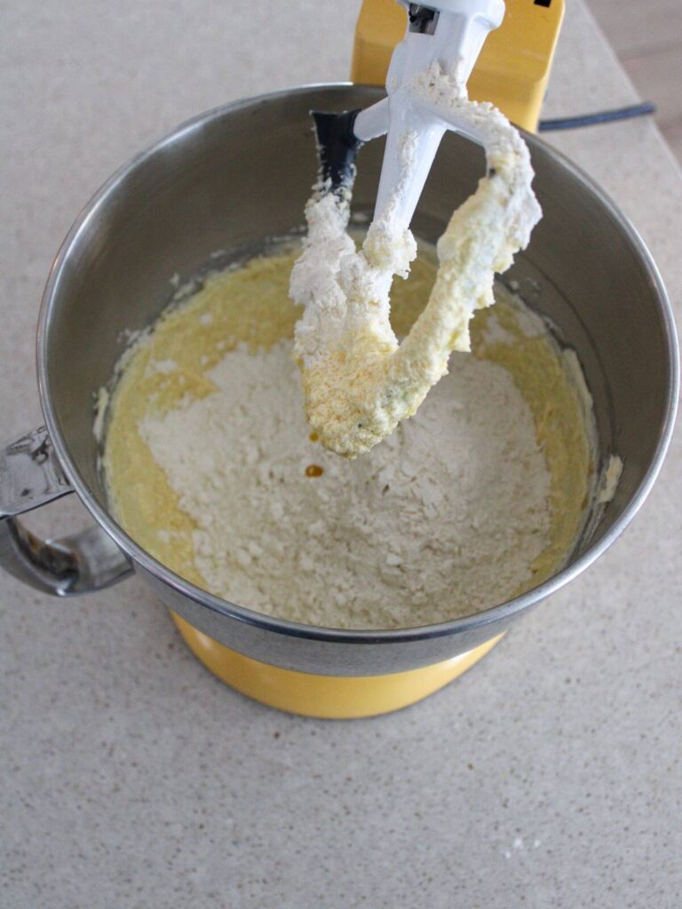 Adding dry ingredients to the wet ingredients in the kitchen aid stand mixture