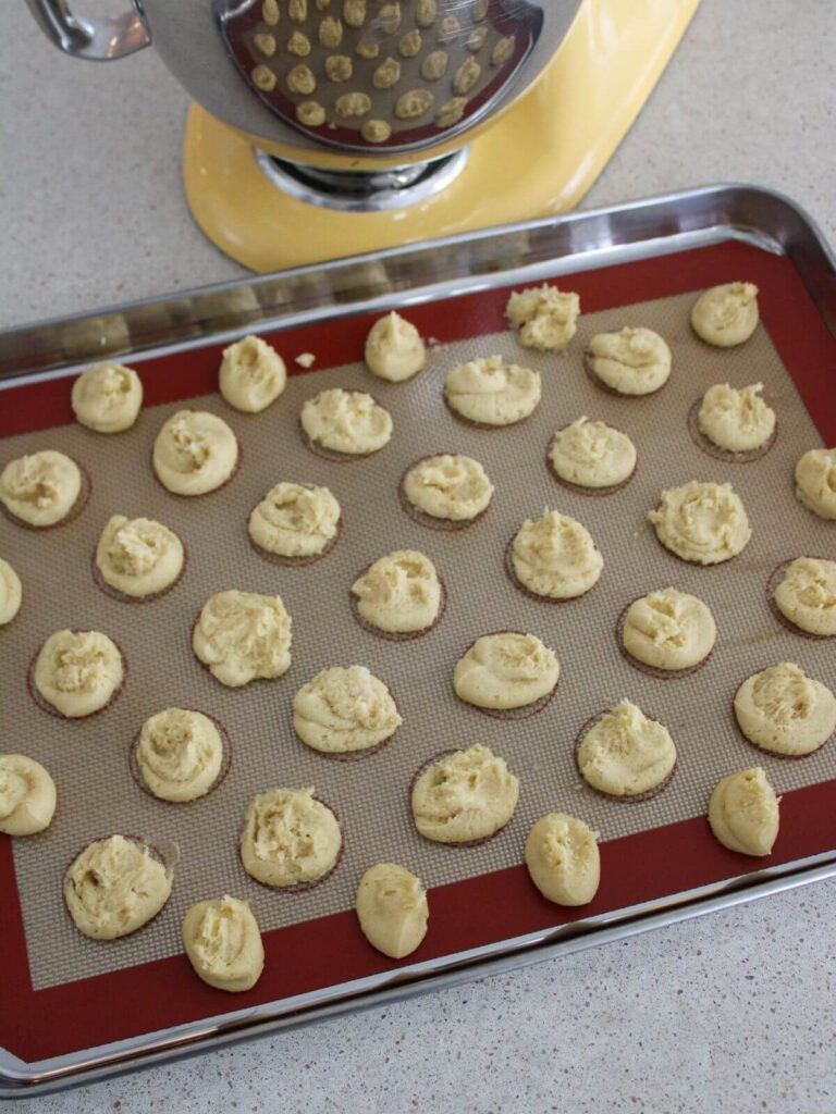 cookies scooped and flattened on a baking sheet ready to bake