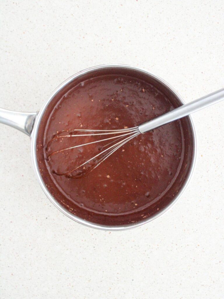 Whisking together all the ingredients with the water in a stainless steel saucepan and whisk