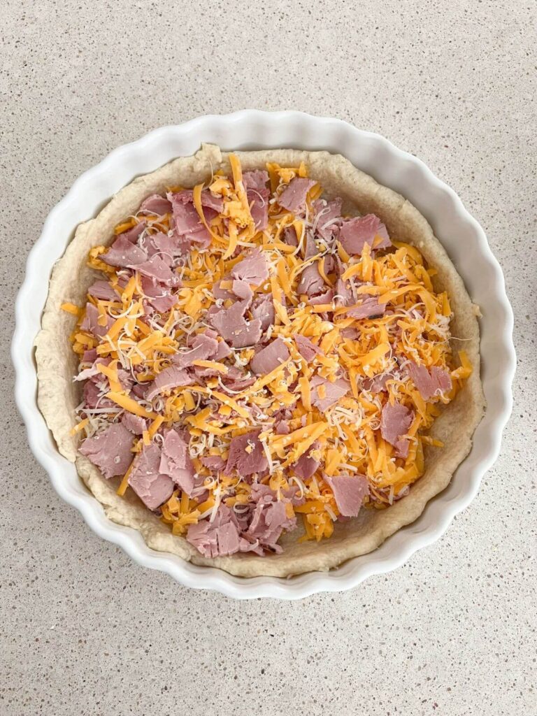 Ham and cheeses mixed and placed in prepared pie crust. 