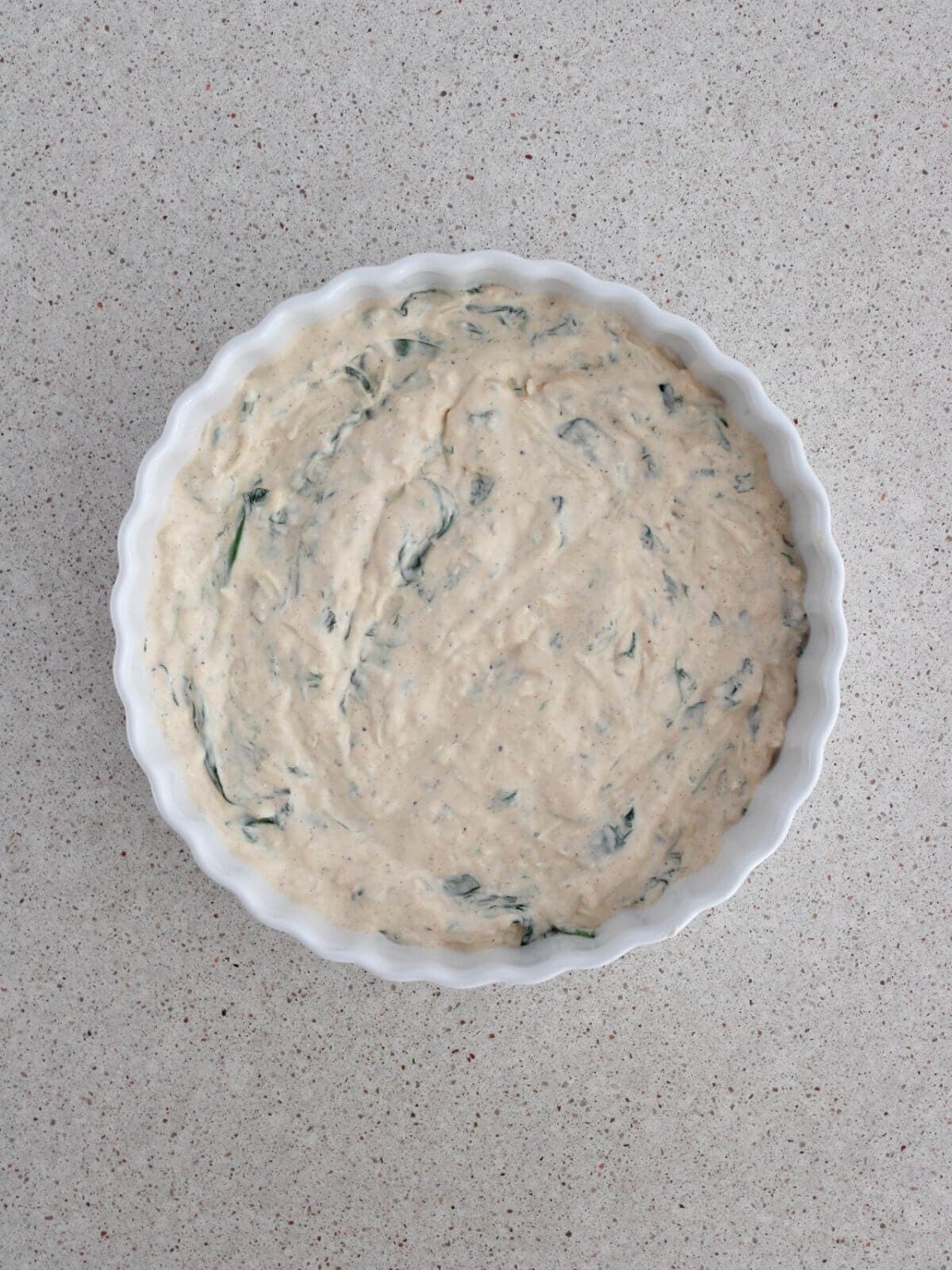 Mixture spread into a baking dish ready for the oven.