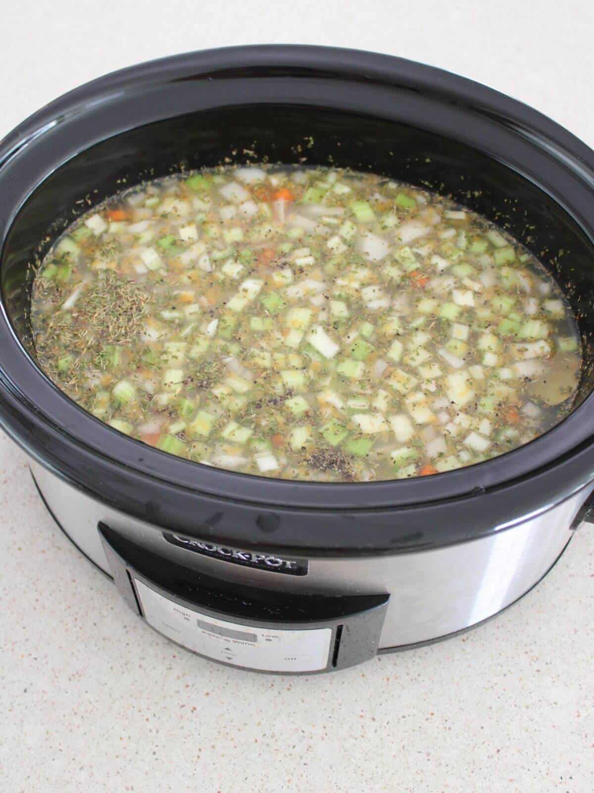 All of the ingredients added to the crockpot and ready to cook.