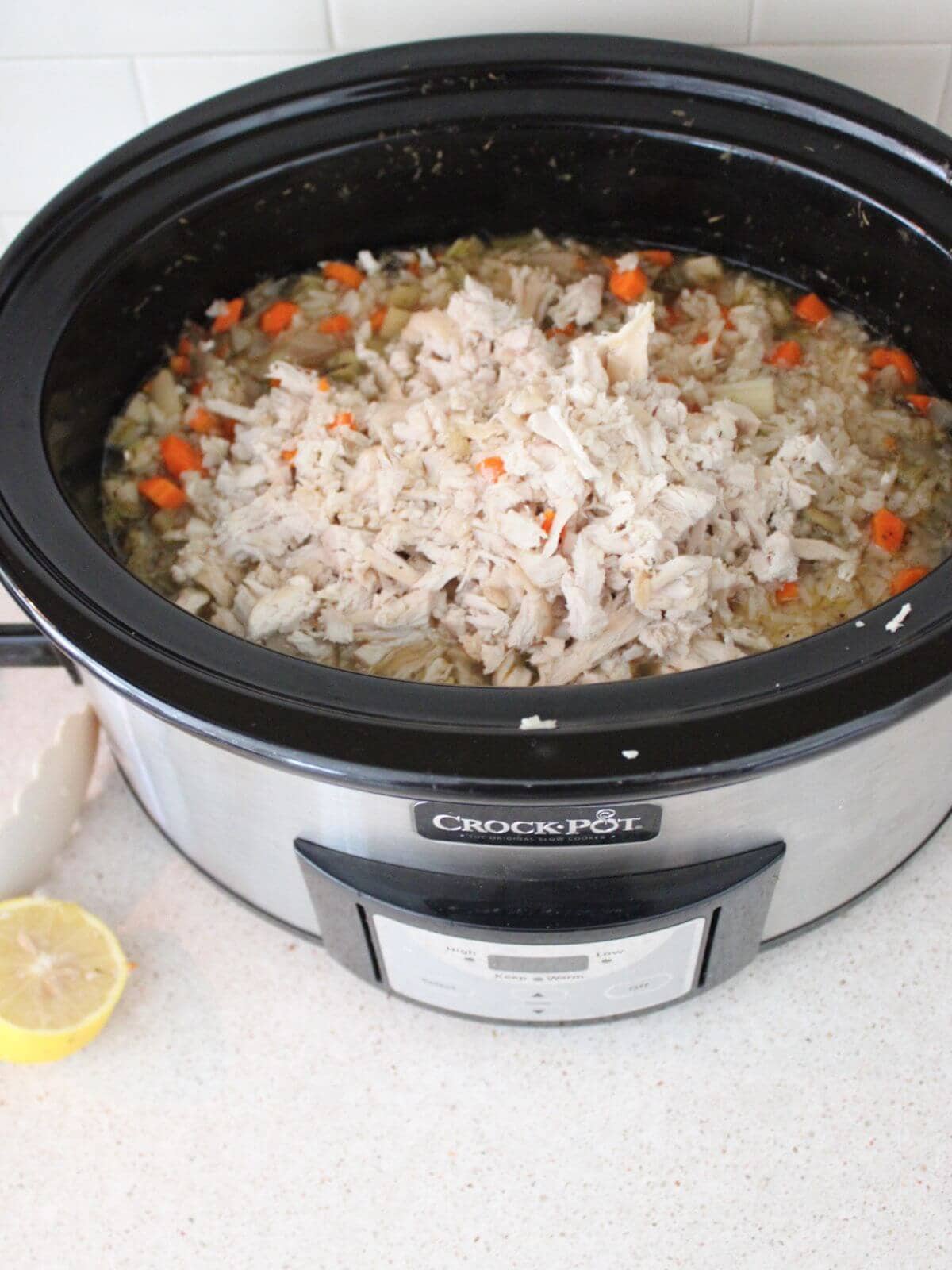 Adding the chicken back in and the lemon juice and string all together in the crockpot.