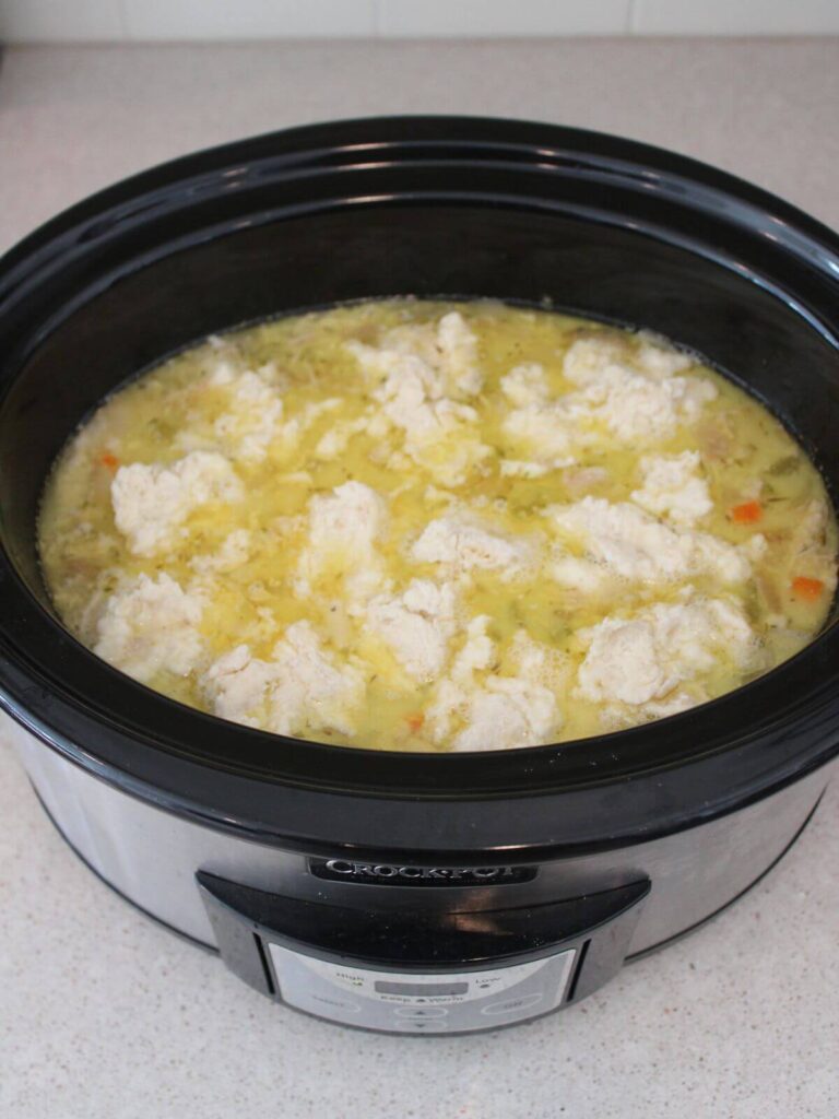 Dumplings added to the stew mixture in the crockpot