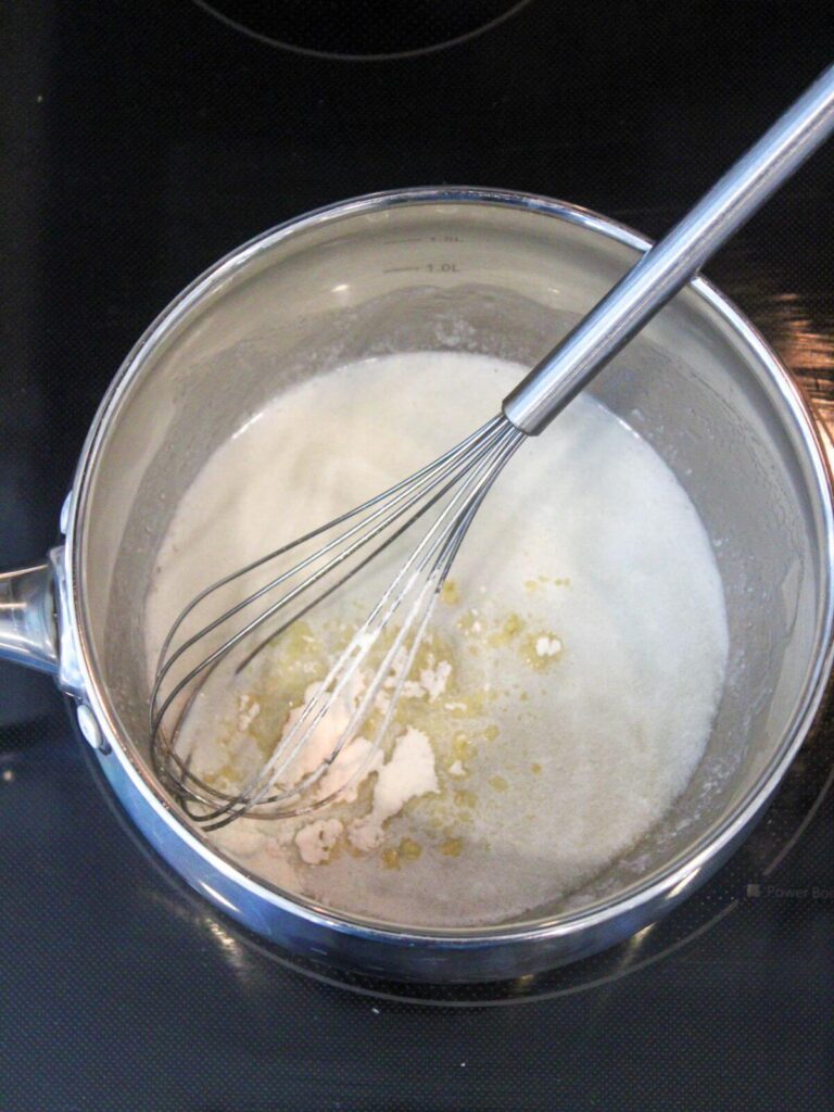 Adding flour to the butter in a stainless steel pan