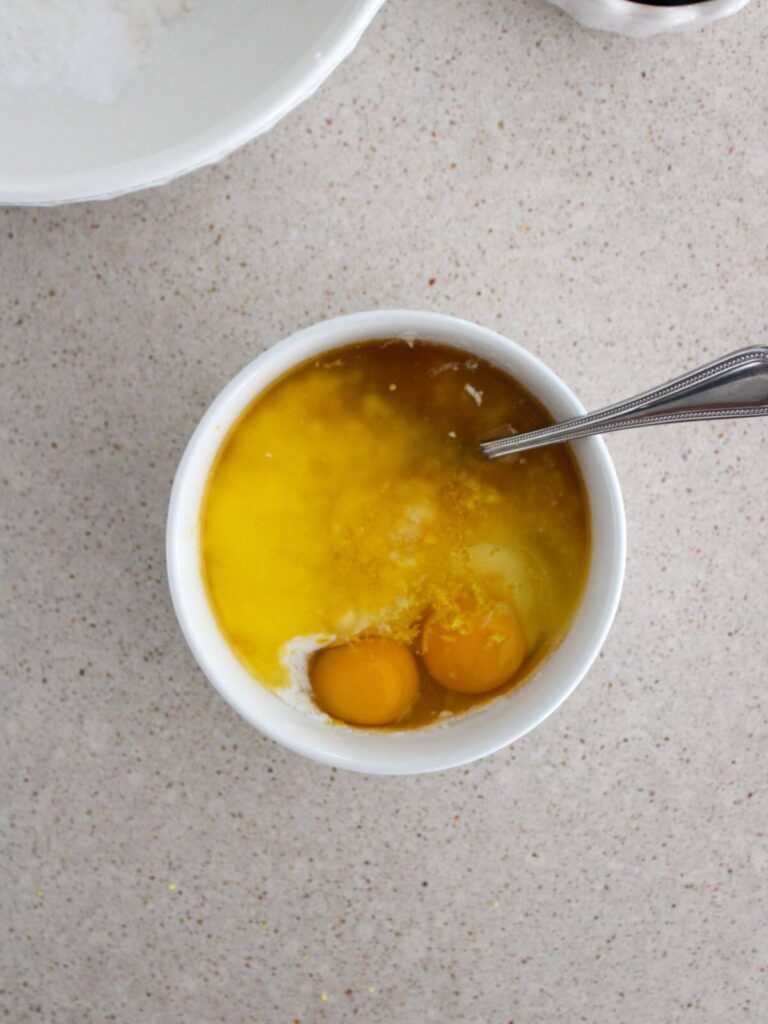 Mixing the wet ingredients together in a small white bowl