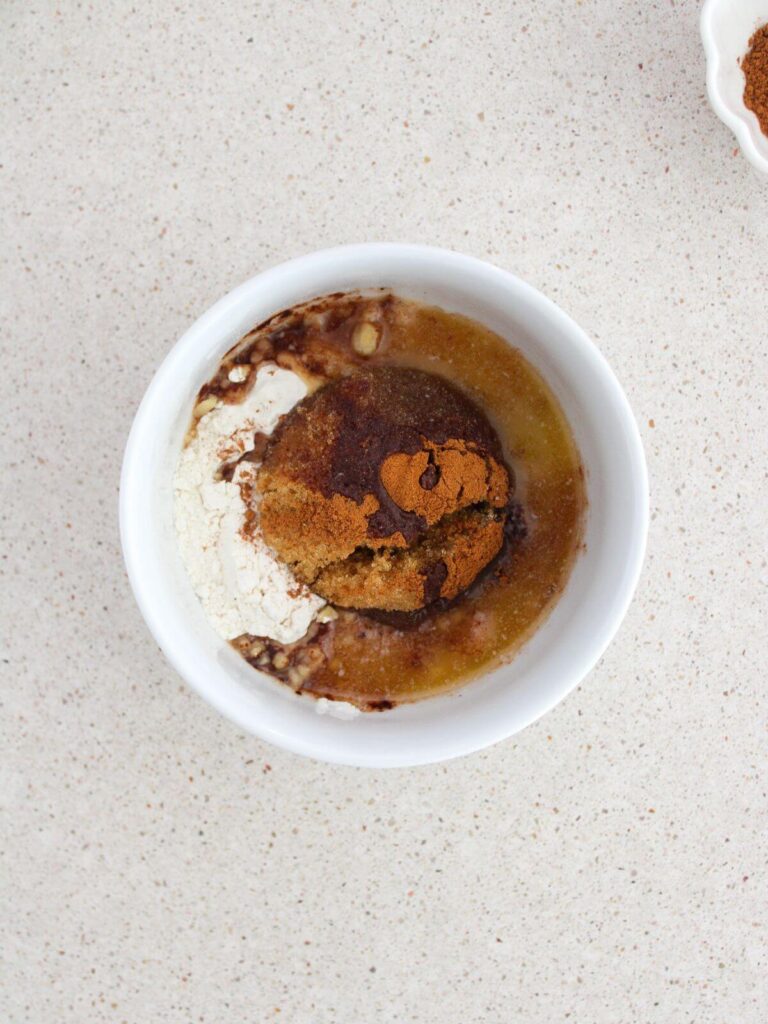 mixing the ingredients in a white bowl to make the crumb topping