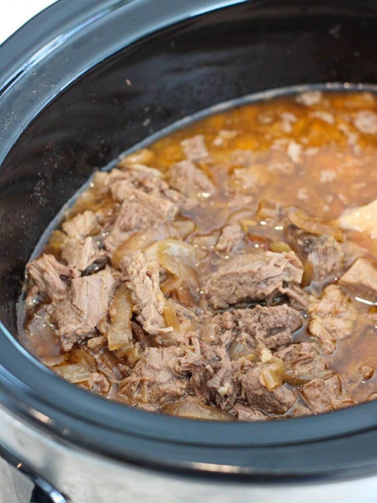shredded roast beef in the crockpot shredded and ready to serve
