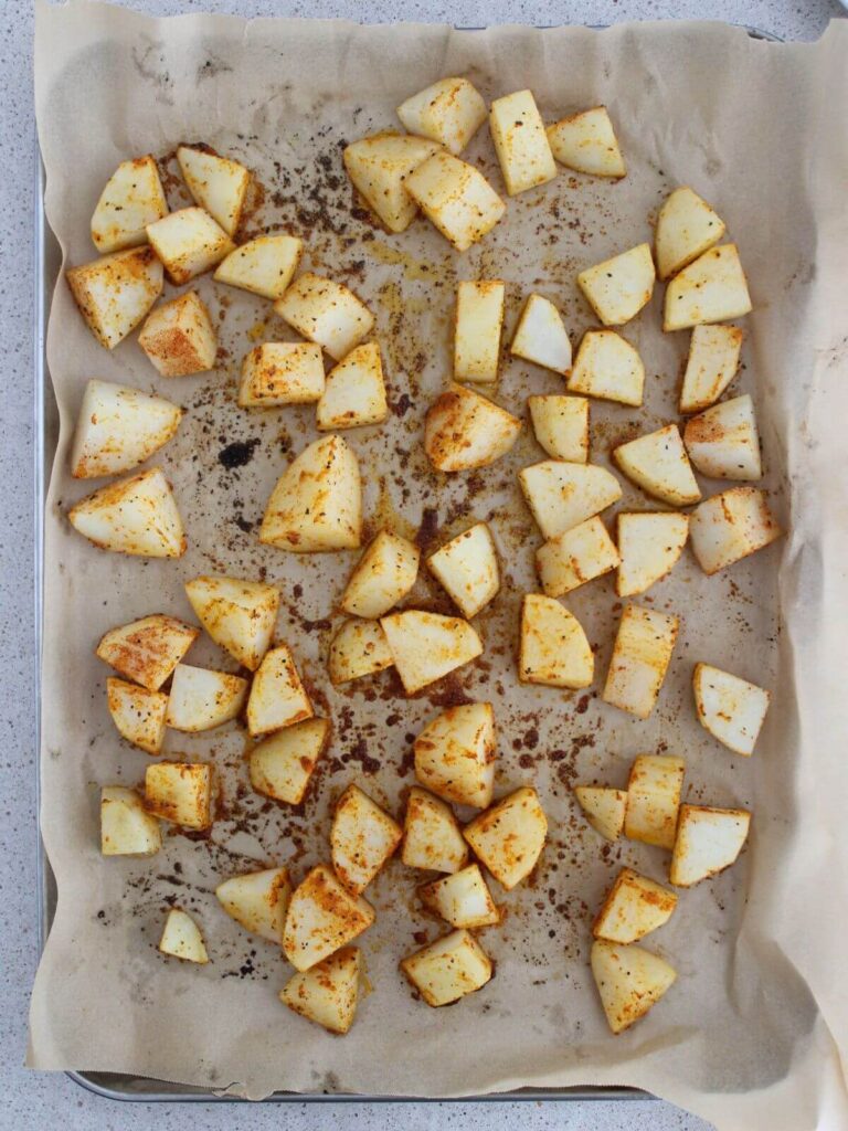 potatoes roasted on a sheet pan with parchment paper