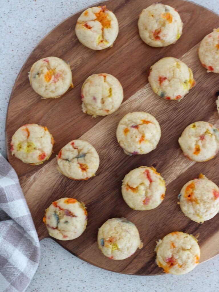 Muffins on a wooden cutting board with a plaid napkin 