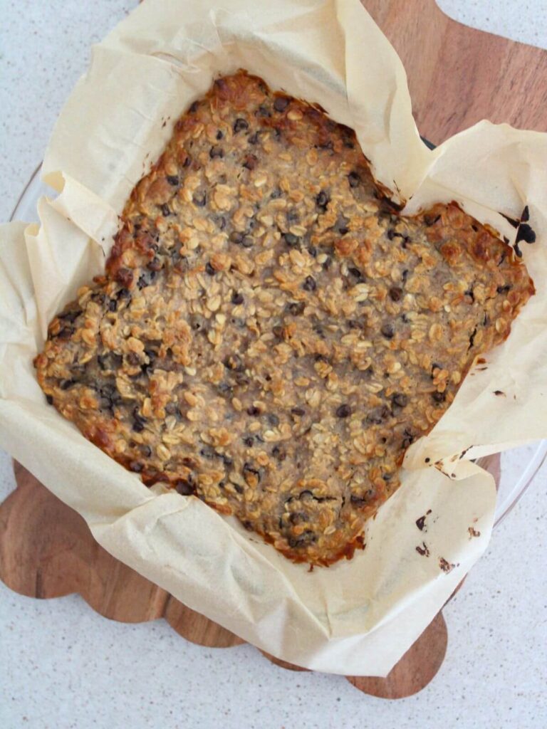peanut butter bars baked in a parchment lined pan