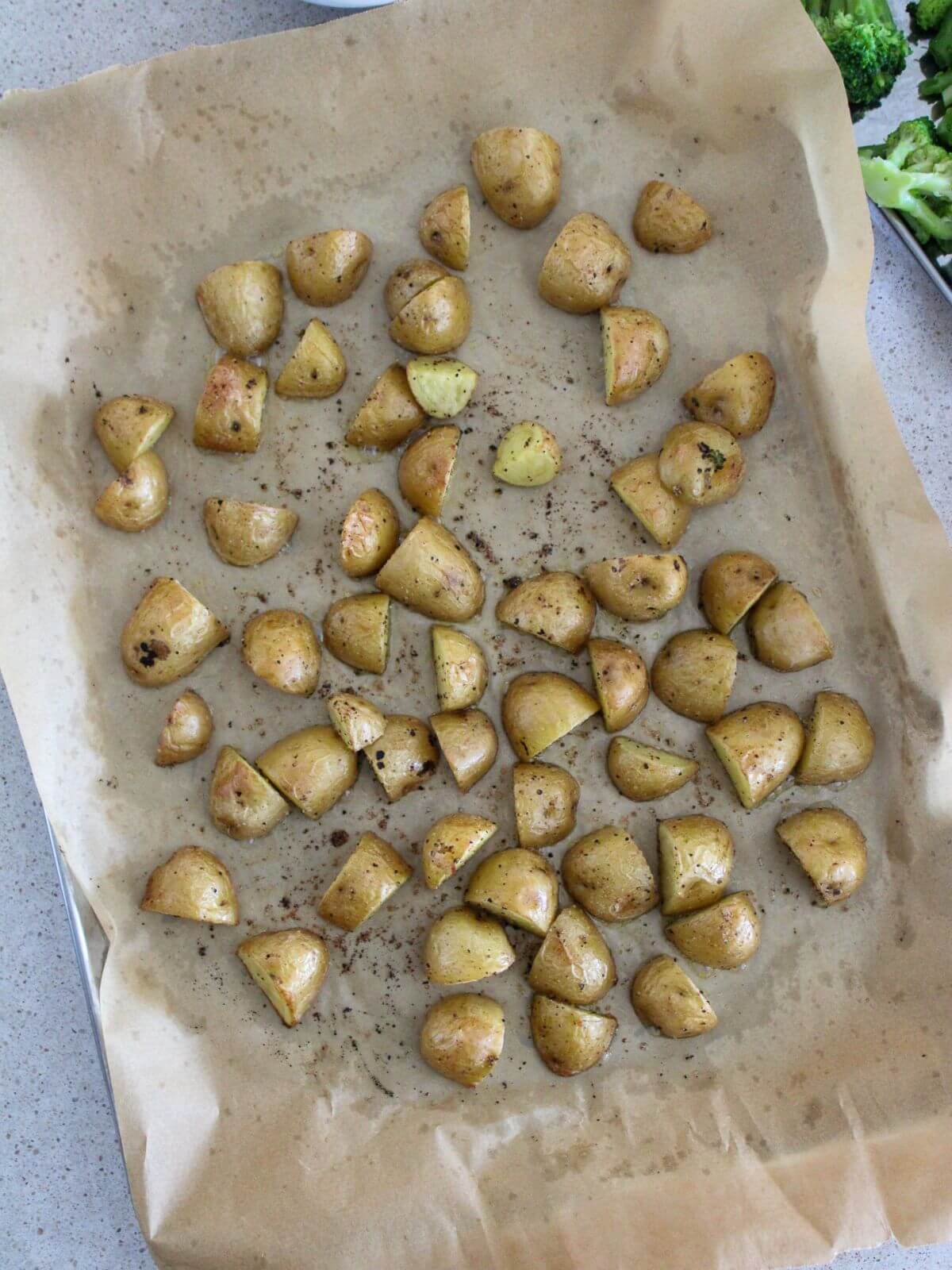 the potatoes roasted on a sheet pan with parchment paper