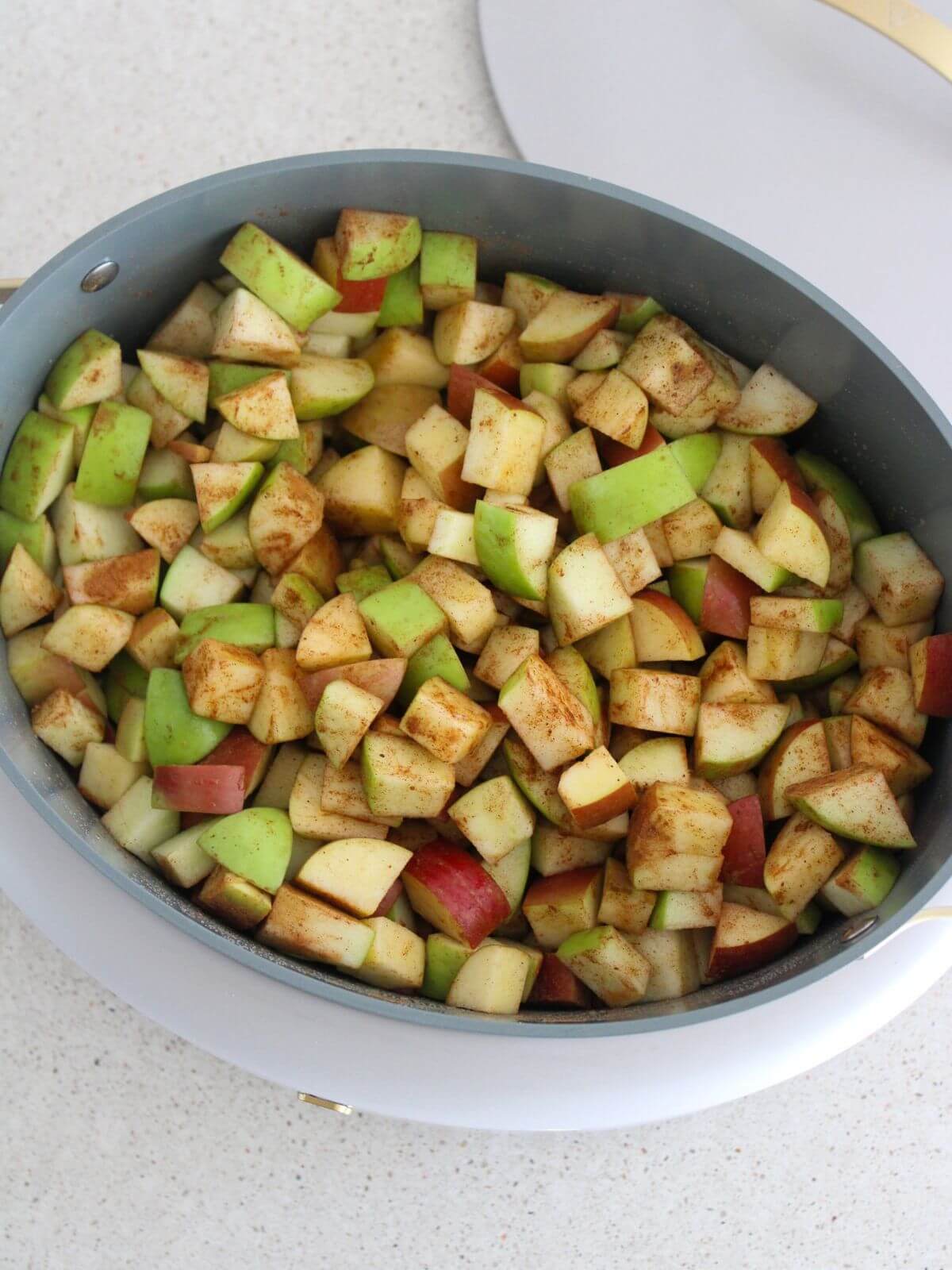 all the ingredients added to the slow cooker mixed and ready to cook